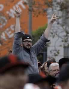 A fan at the Giants parade salutes his true Lord, Satan.